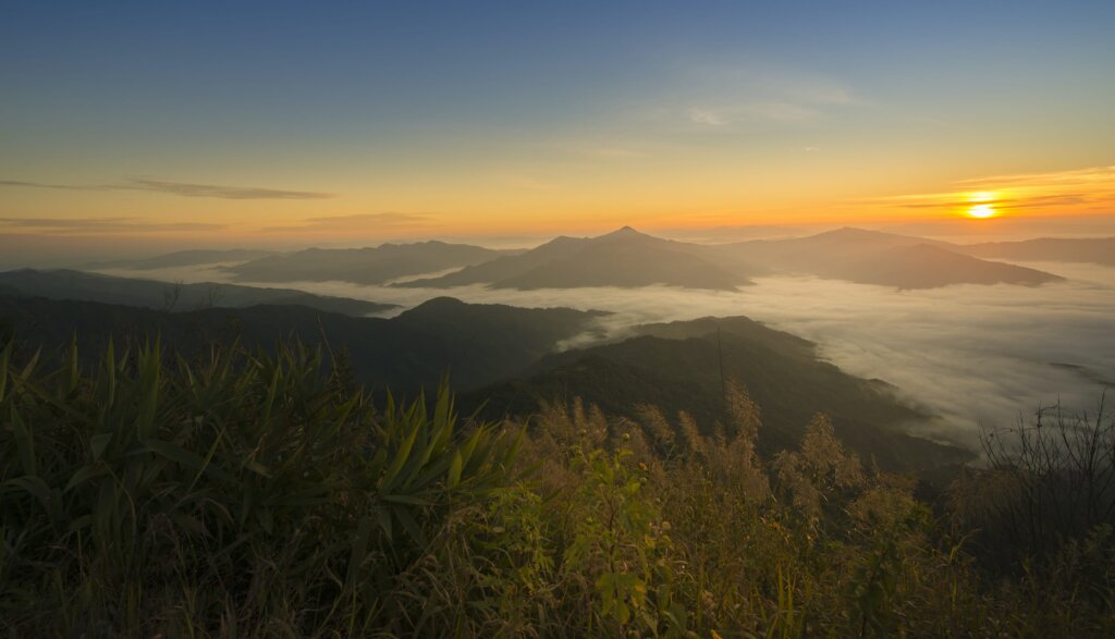 Watching the sun rising slowly from behind the mountains - one of the best things to do in Chiang Rai Province Thailand