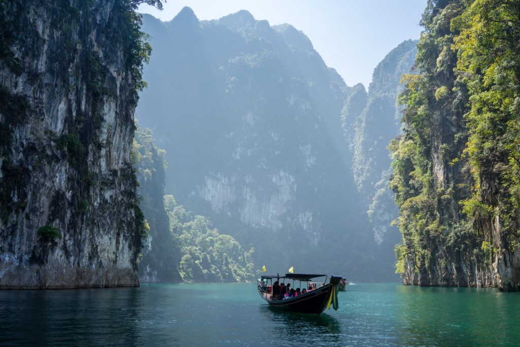 Explore the breathtaking wonders of nature! Relax on an early morning longtail boat trip with your friends in Southern Thailand's deep clear-blue waters!